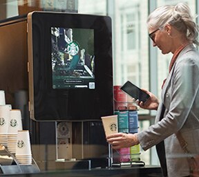 Woman Uses Touchless Starbucks Serenade Brewer in Apartment Common Area Woman Uses Touchless Starbucks Serenade Brewer in Apartment Common Area