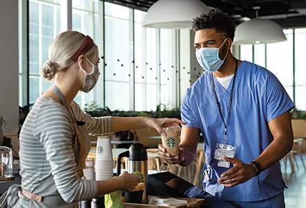 Barista Serves Doctor a Cup of Starbucks Coffee in a Hospital Cafeteria Barista Serves Doctor a Cup of Starbucks Coffee in a Hospital Cafeteria
