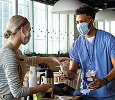 Barista Serves Doctor a Cup of Starbucks Coffee in a Hospital Cafeteria Barista Serves Doctor a Cup of Starbucks Coffee in a Hospital Cafeteria