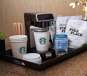 Starbucks Coffee Station in a Hotel Room With Starbucks Coffee Cups and Lids, Pike Place Coffee Bags,and Brewing Machine Starbucks Coffee Station in a Hotel Room With Starbucks Coffee Cups and Lids, Pike Place Coffee Bags,and Brewing Machine