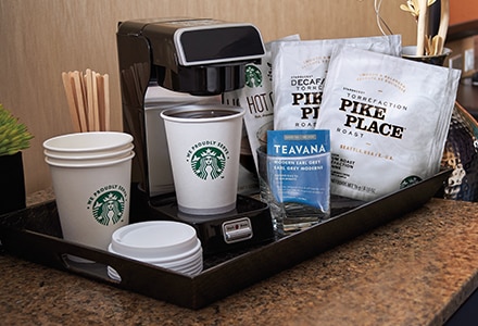 Starbucks Coffee Station in a Hotel Room With Starbucks Coffee Cups and Lids, Pike Place Coffee Bags,and Brewing Machine Starbucks Coffee Station in a Hotel Room With Starbucks Coffee Cups and Lids, Pike Place Coffee Bags,and Brewing Machine