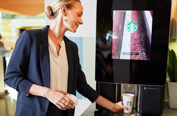 Woman Using Starbucks Serenade Coffee Machine